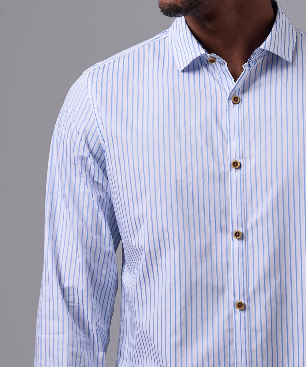 CAMISA MANGA LARGA PECHERA OJAL SLIM FIT CELESTE C/RAYAS OI25